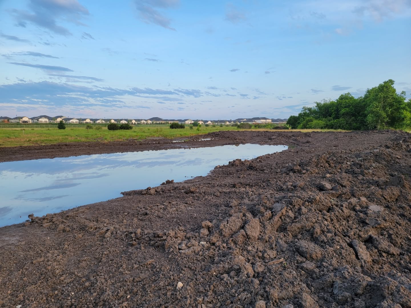 Earthen dam embankment under construction with rock armouring