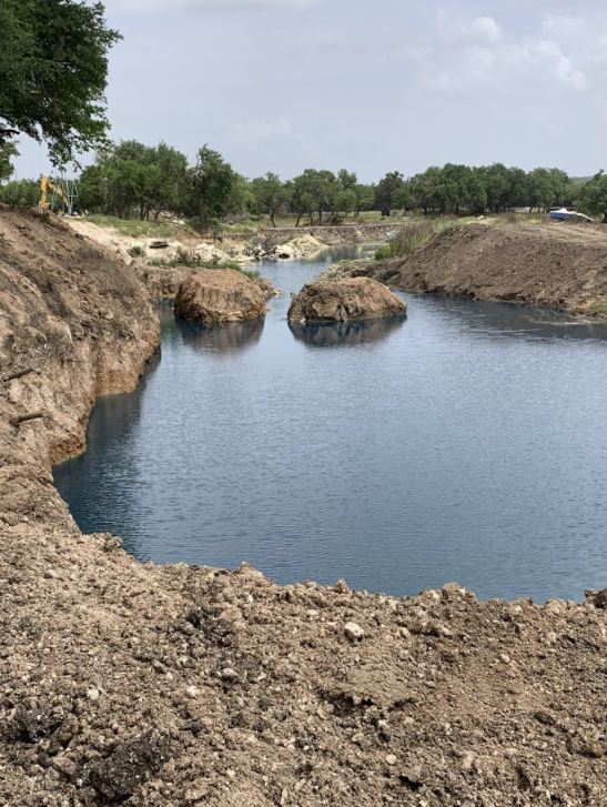 New pond filling with water after construction